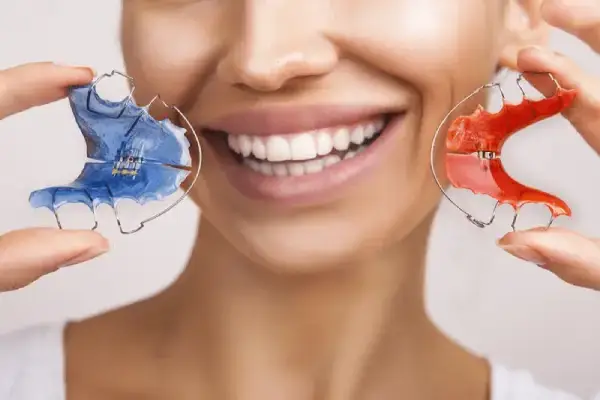 a woman showing retainer braces